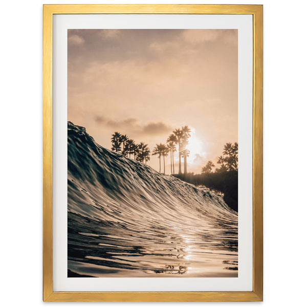 a picture of a wave in the ocean with palm trees in the background