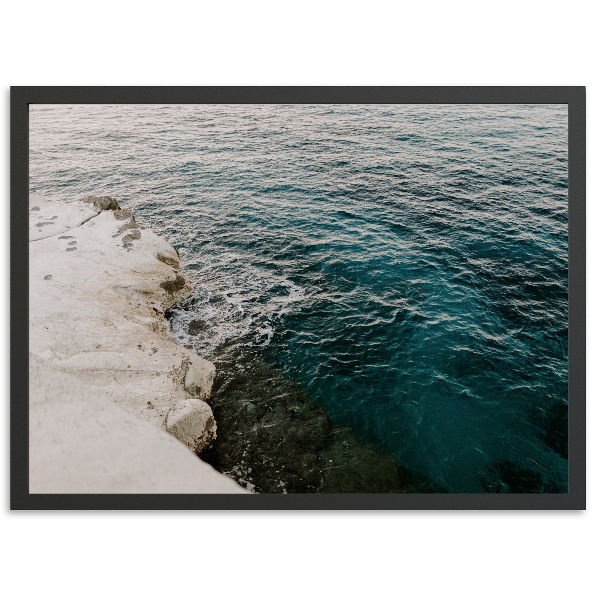 a picture of a body of water next to a cliff