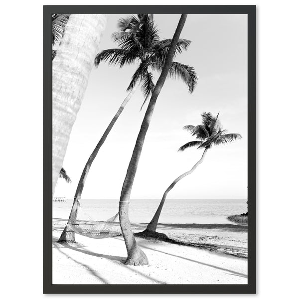 a black and white photo of palm trees on a beach