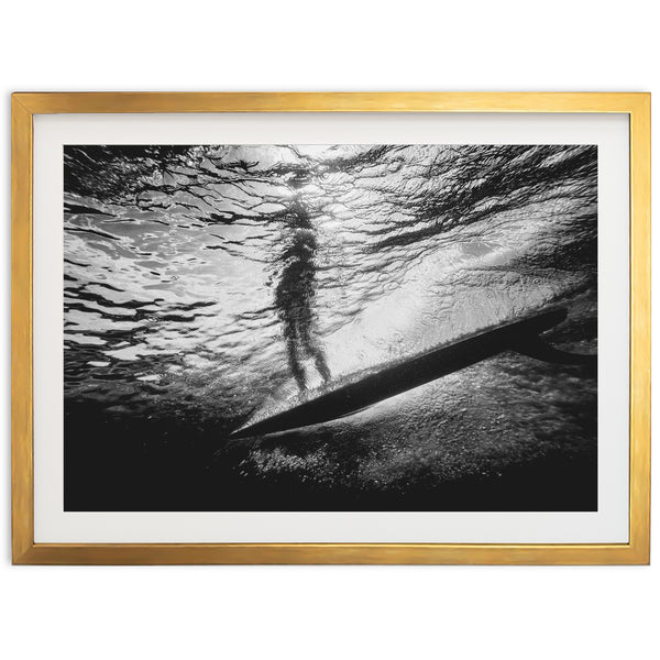 a black and white photo of a person on a surfboard