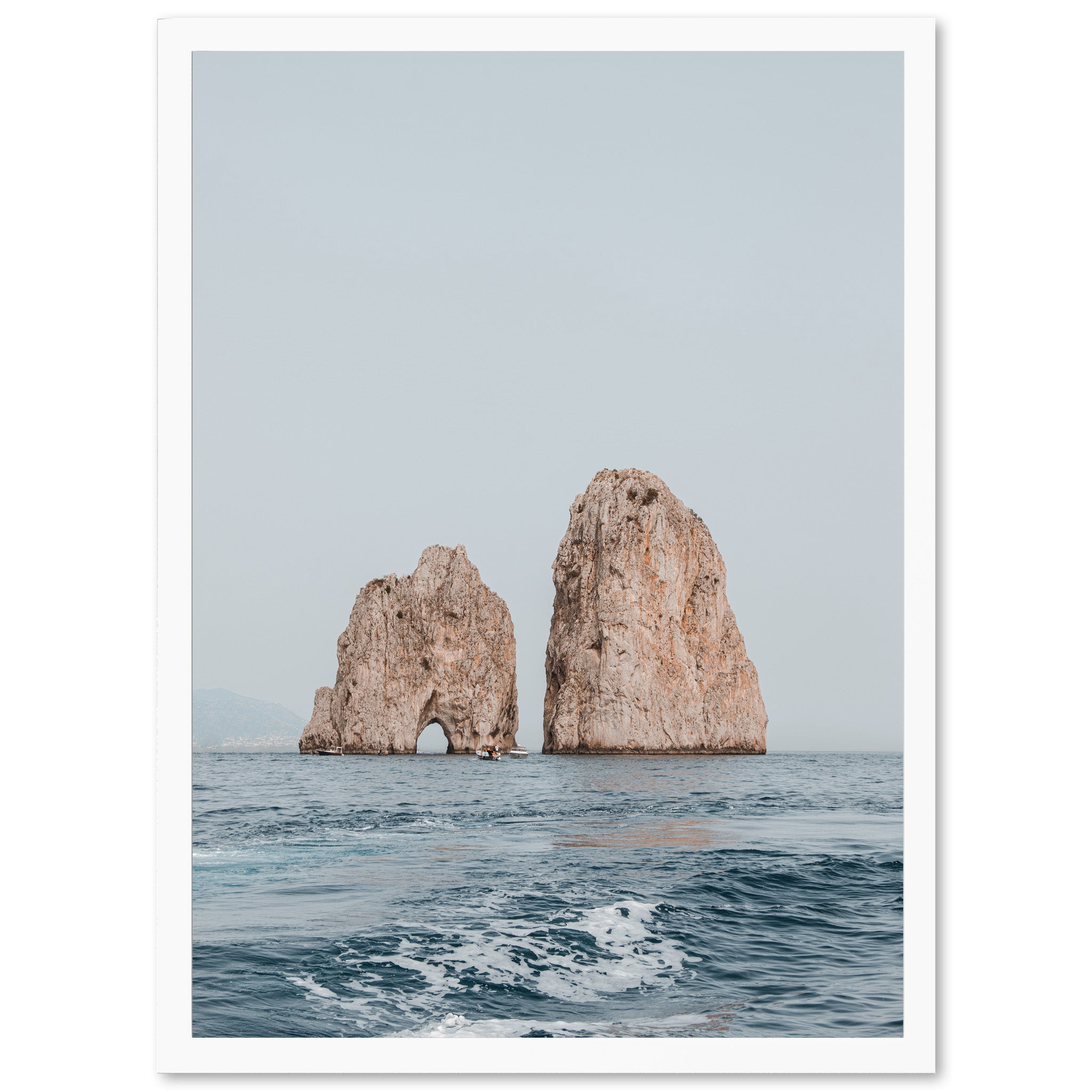 two large rocks in the middle of the ocean