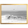 a black and white photo of a boat in the ocean