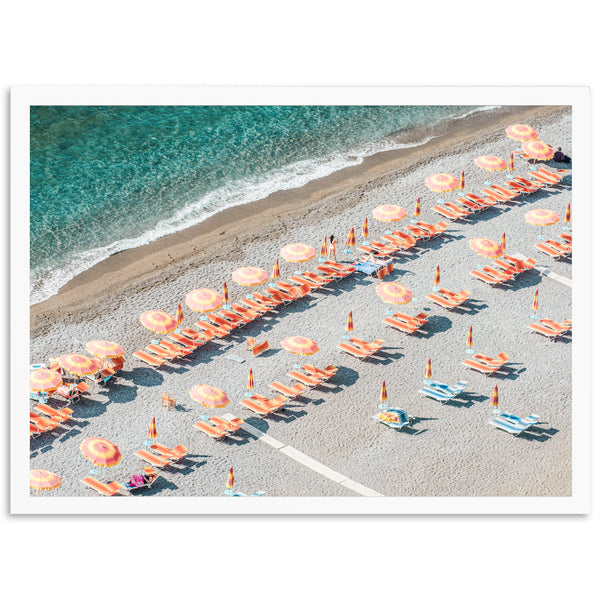 an aerial view of a beach with umbrellas and chairs