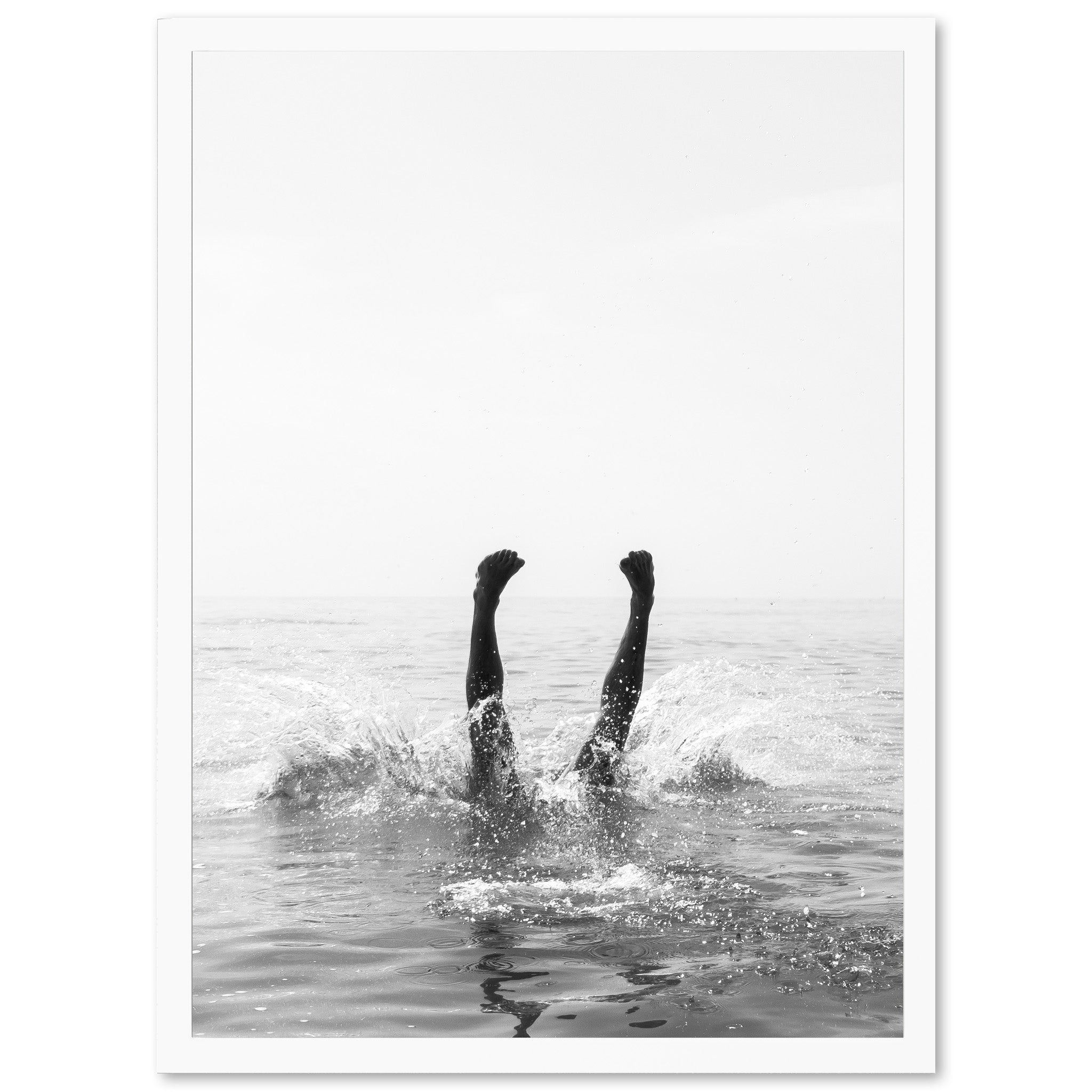 a black and white photo of a person swimming in the ocean