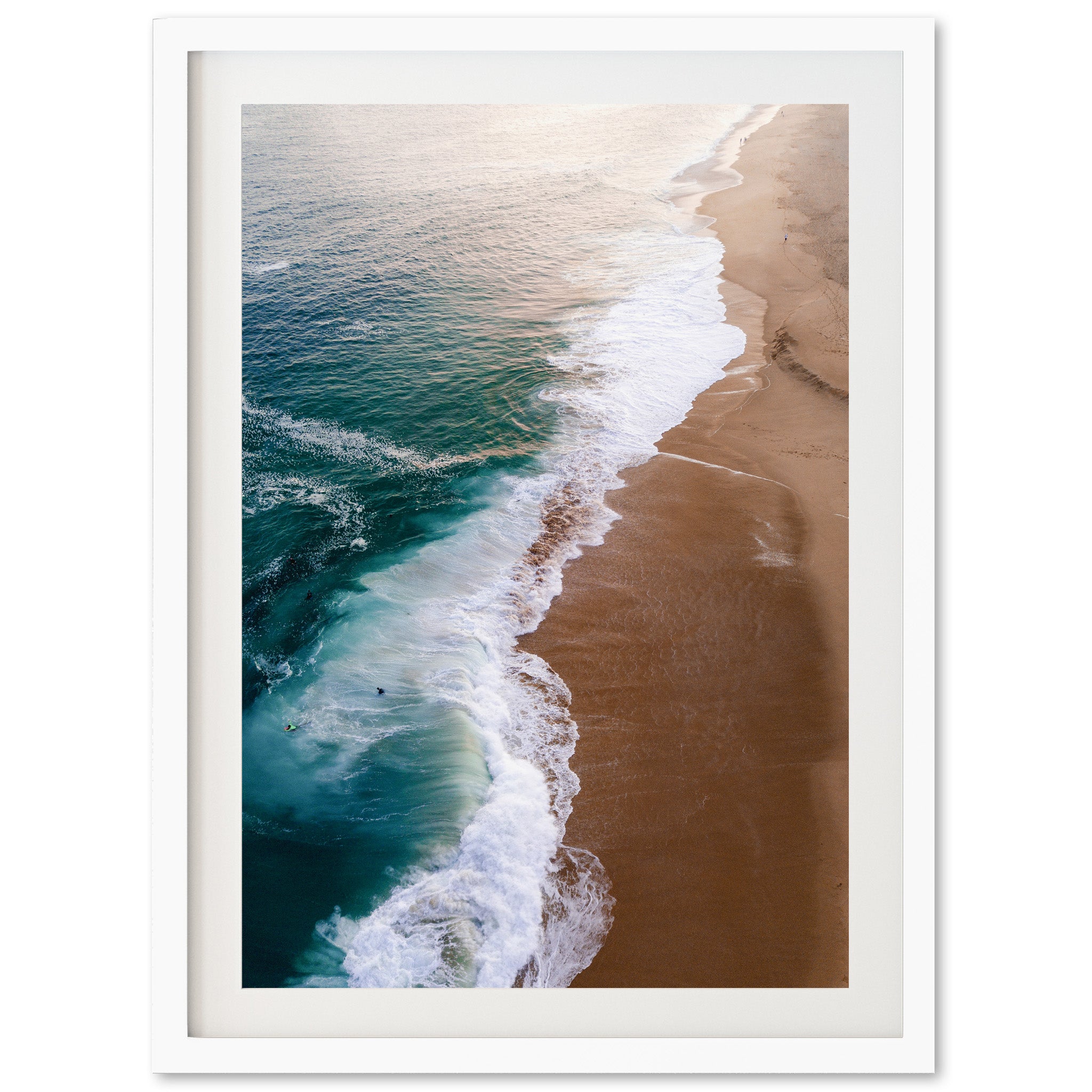 an aerial view of a beach with waves coming in