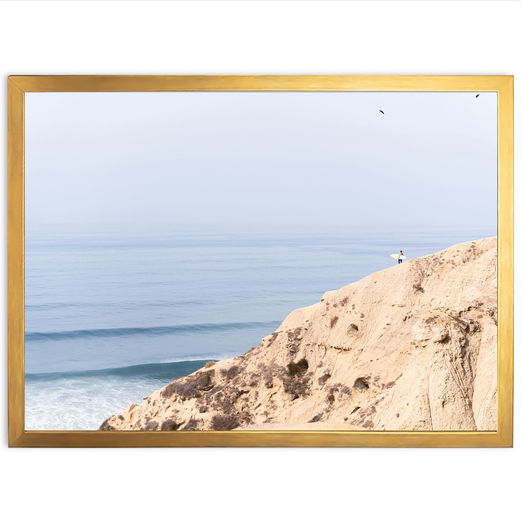 a picture of a person standing on a cliff overlooking the ocean