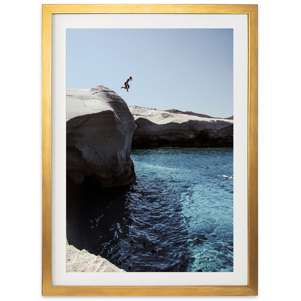 a person jumping off a cliff into a body of water