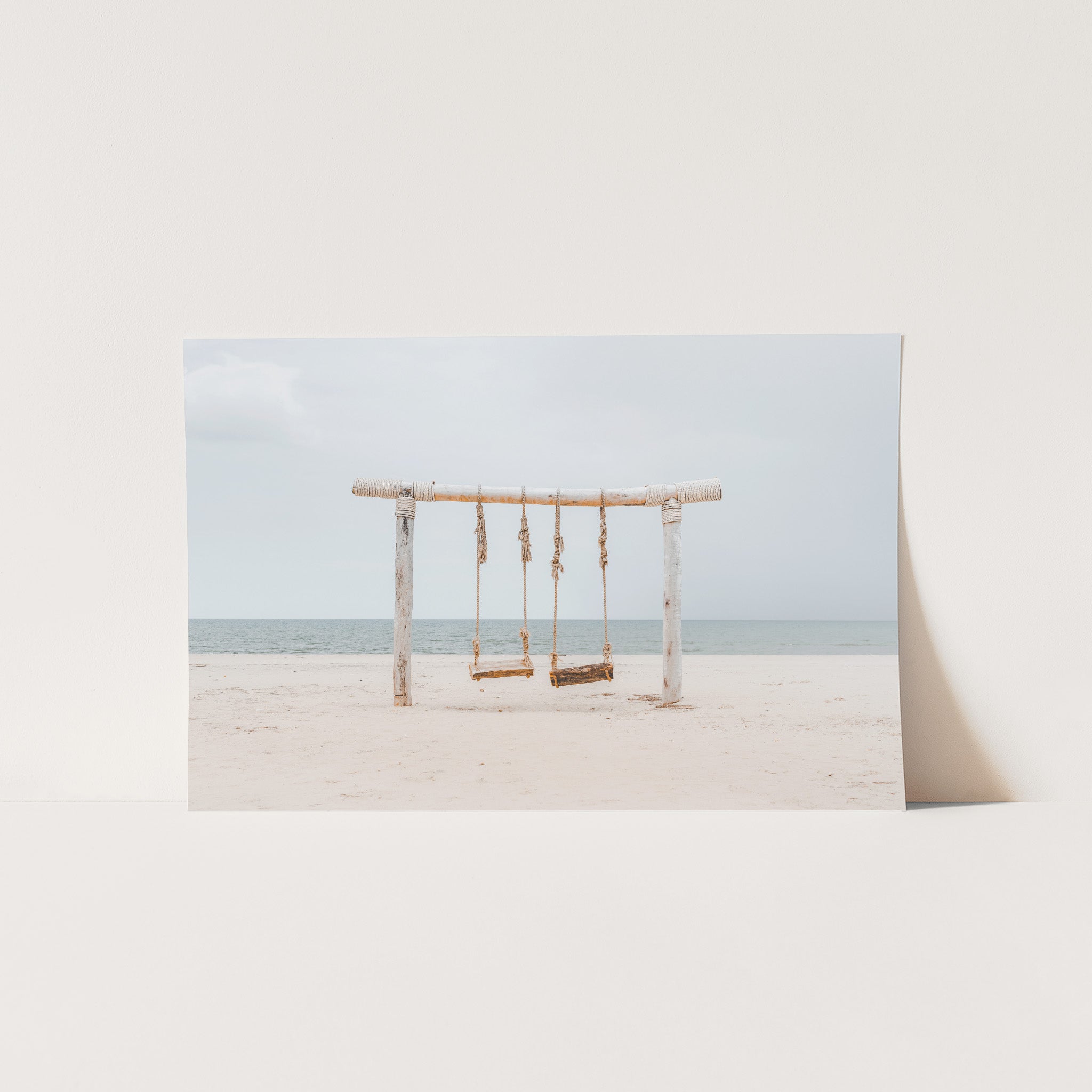 a picture of a swing set on a beach