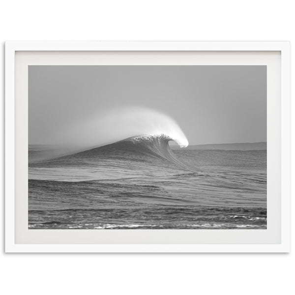 a black and white photo of a wave in the ocean