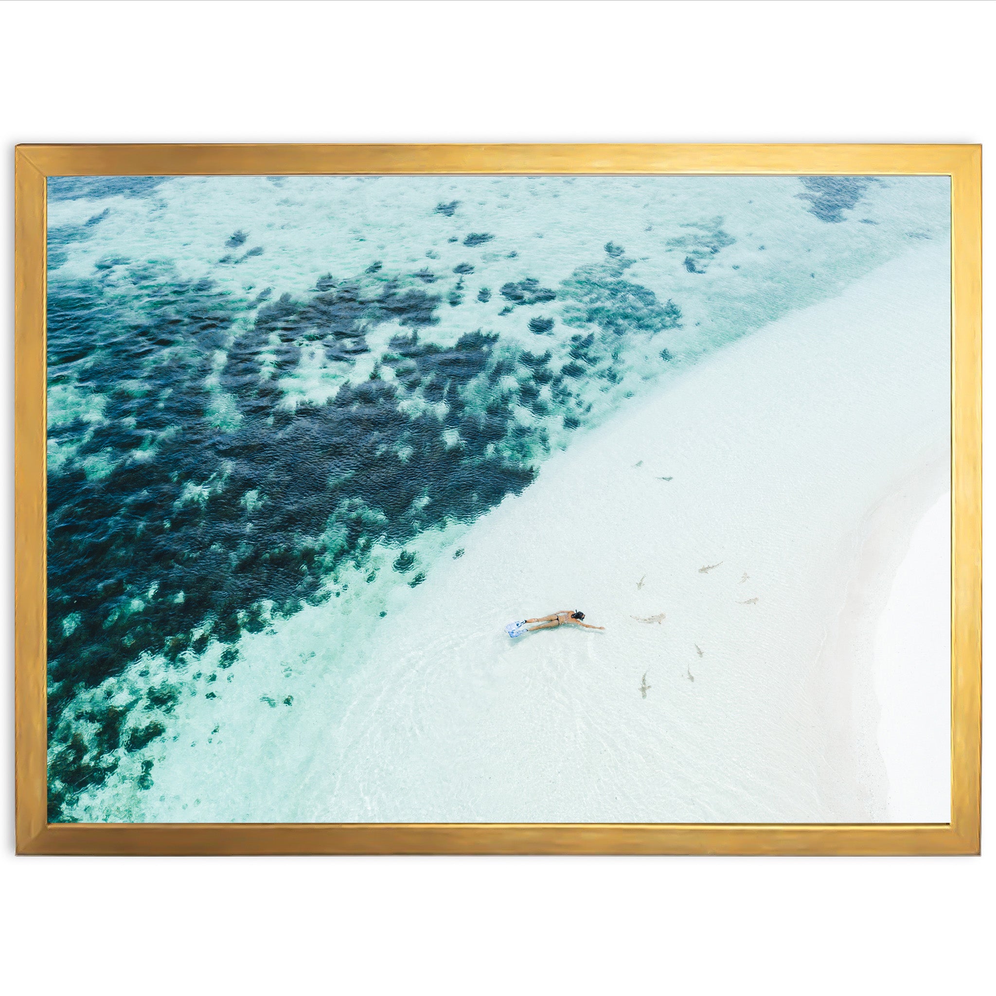 an aerial view of a beach with a boat in the water