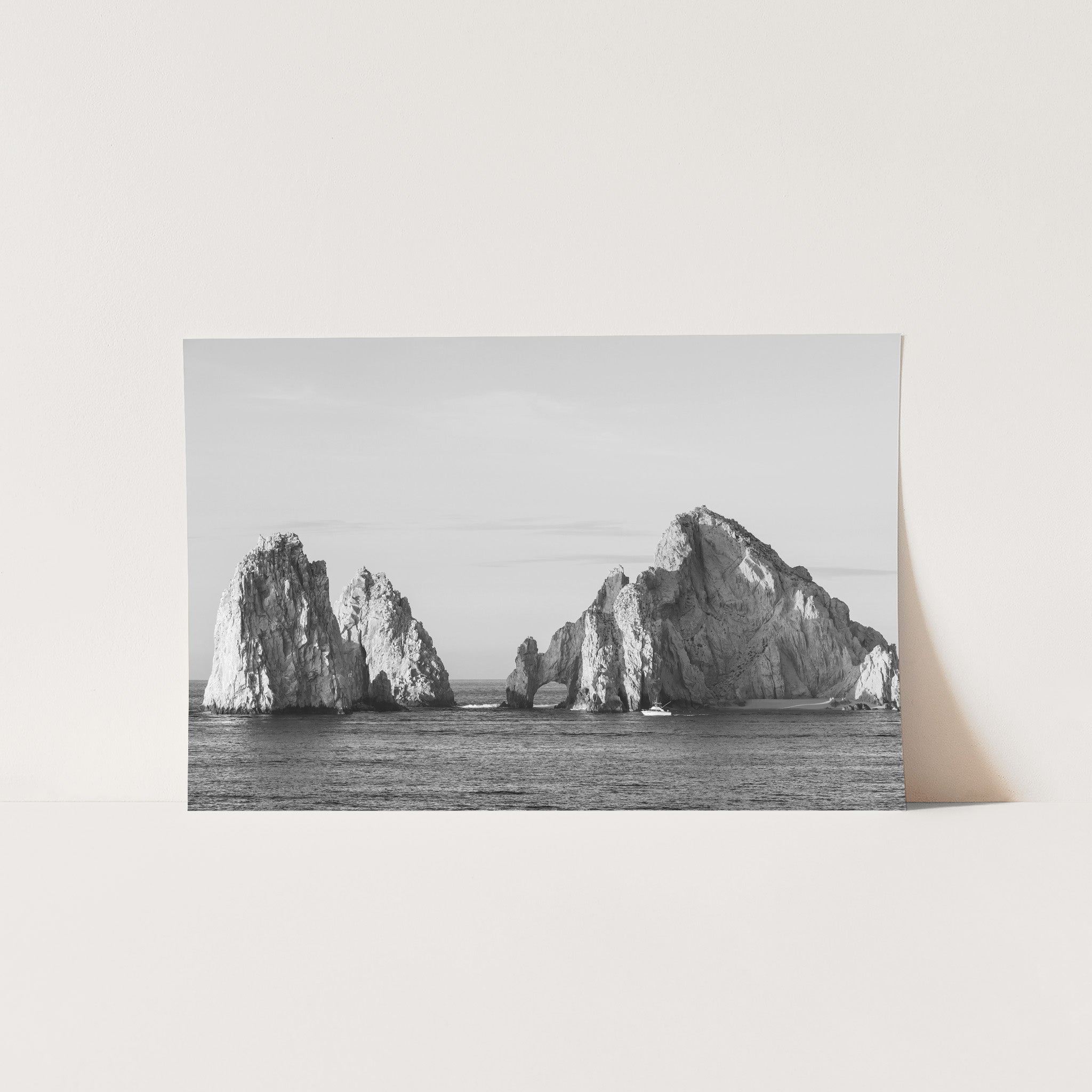 a black and white photo of rocks in the ocean