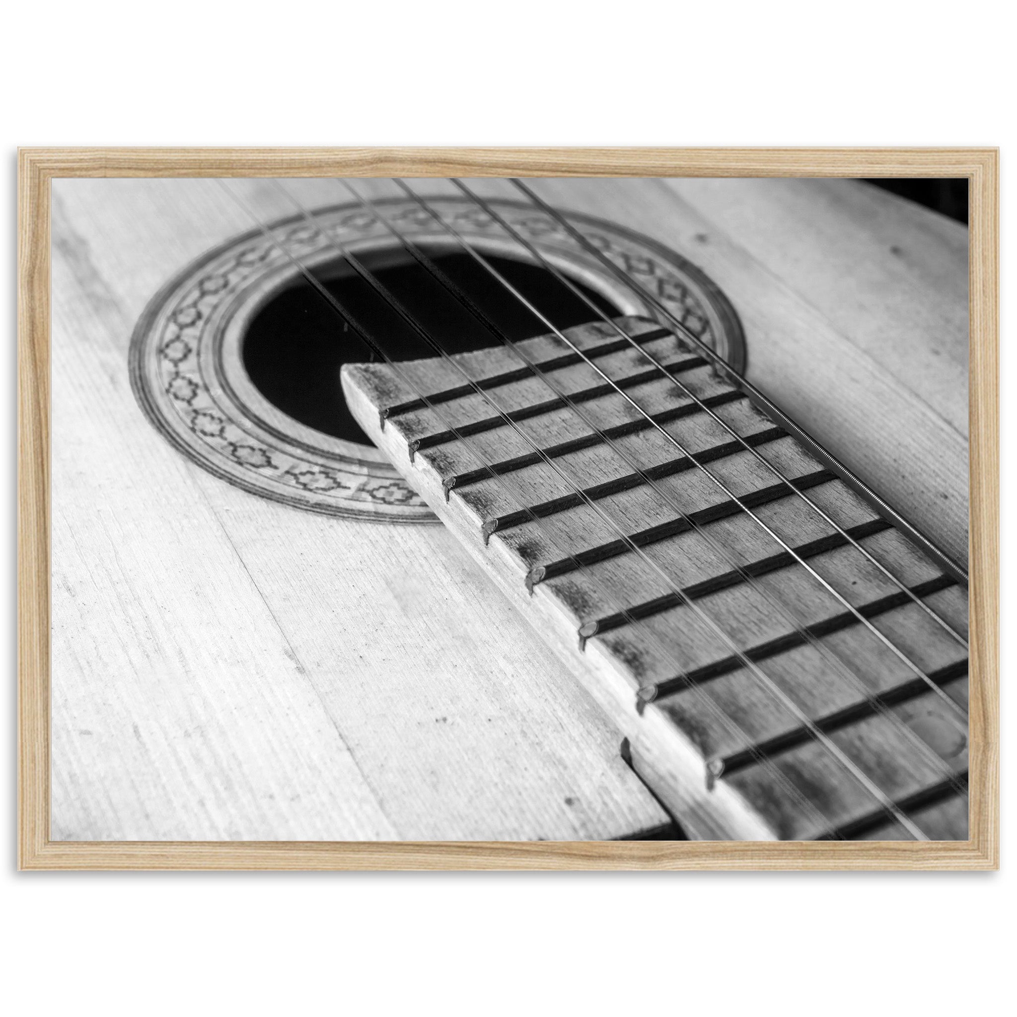 a black and white photo of an acoustic guitar