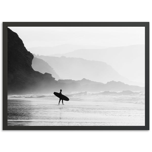 a black and white photo of a person holding a surfboard