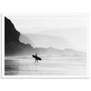 a black and white photo of a person carrying a surfboard