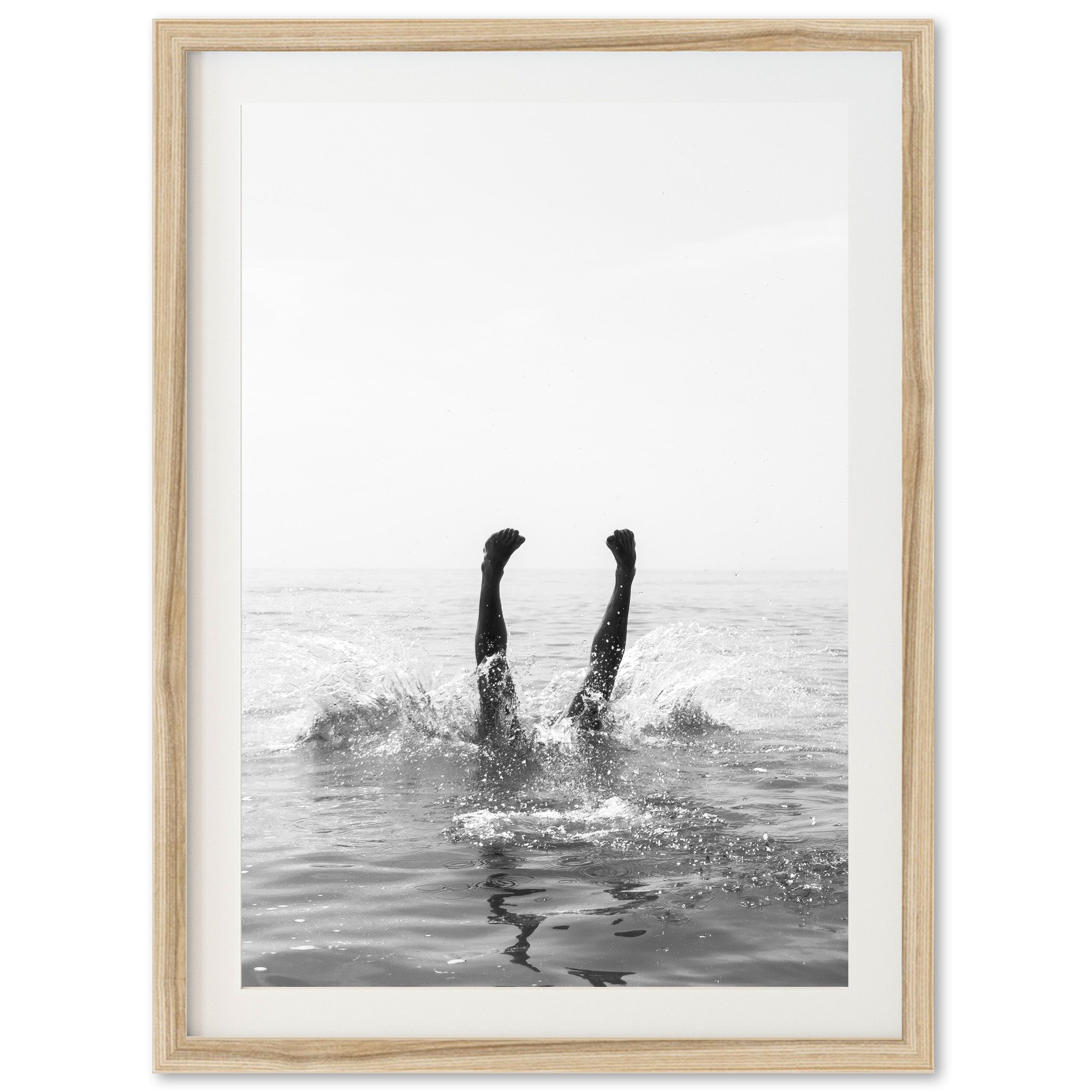 a black and white photo of two people in the water