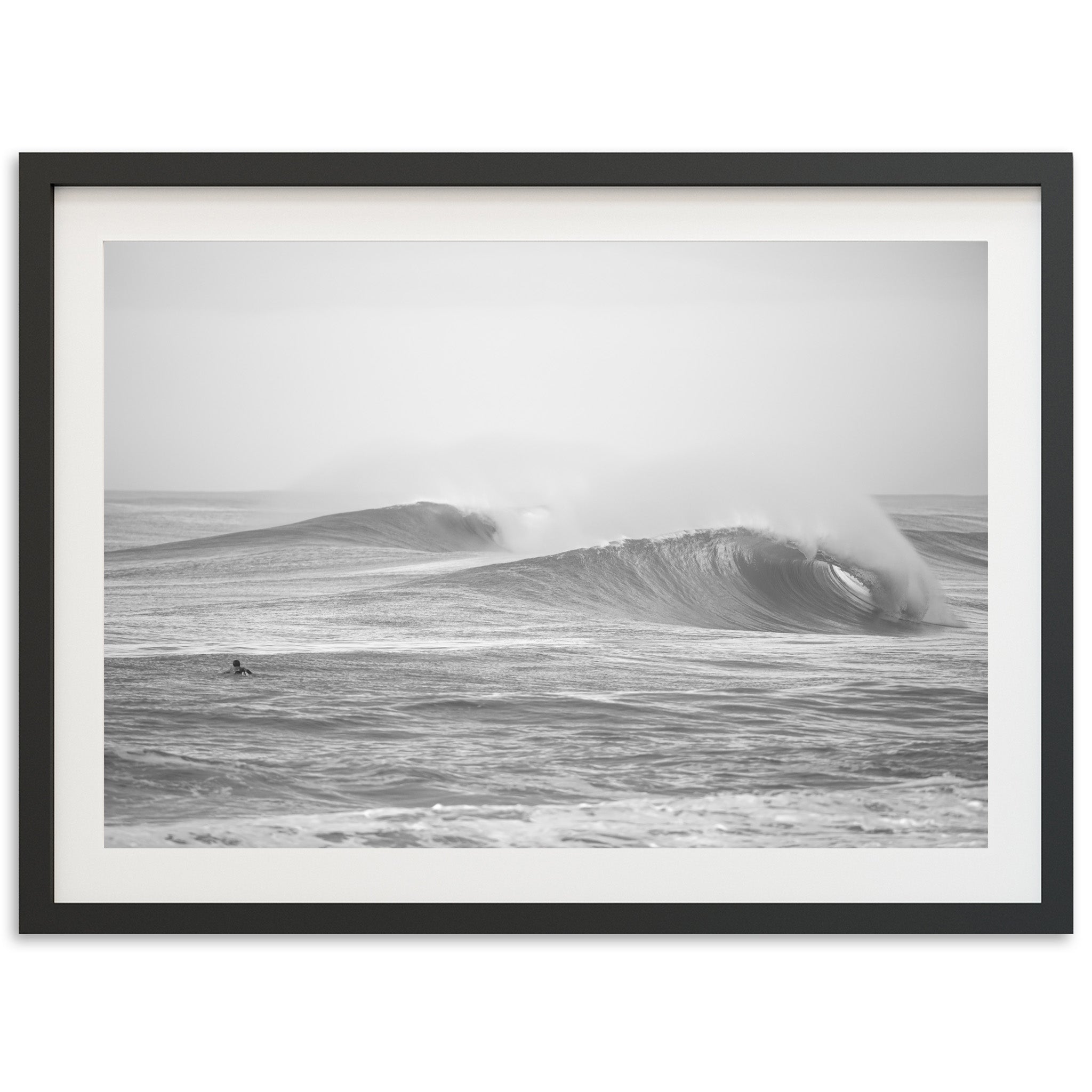 a black and white photo of a large wave