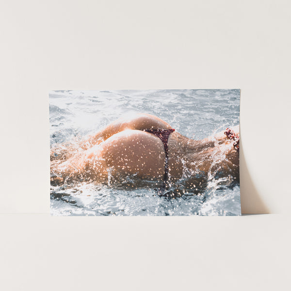 a picture of a woman swimming in the ocean