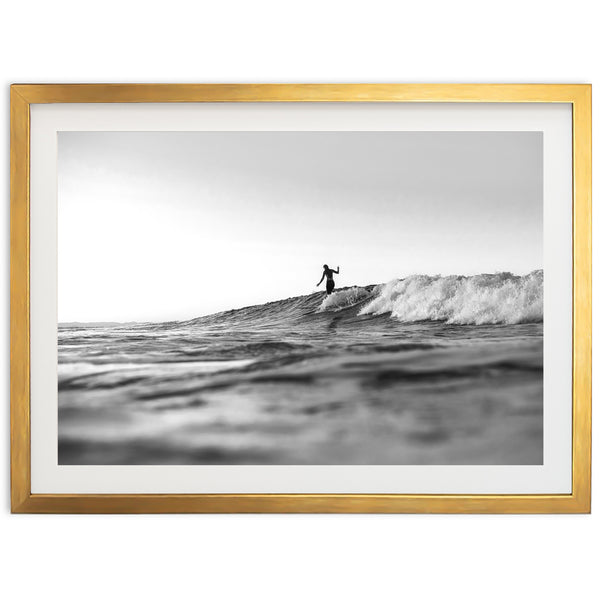 a black and white photo of a surfer riding a wave