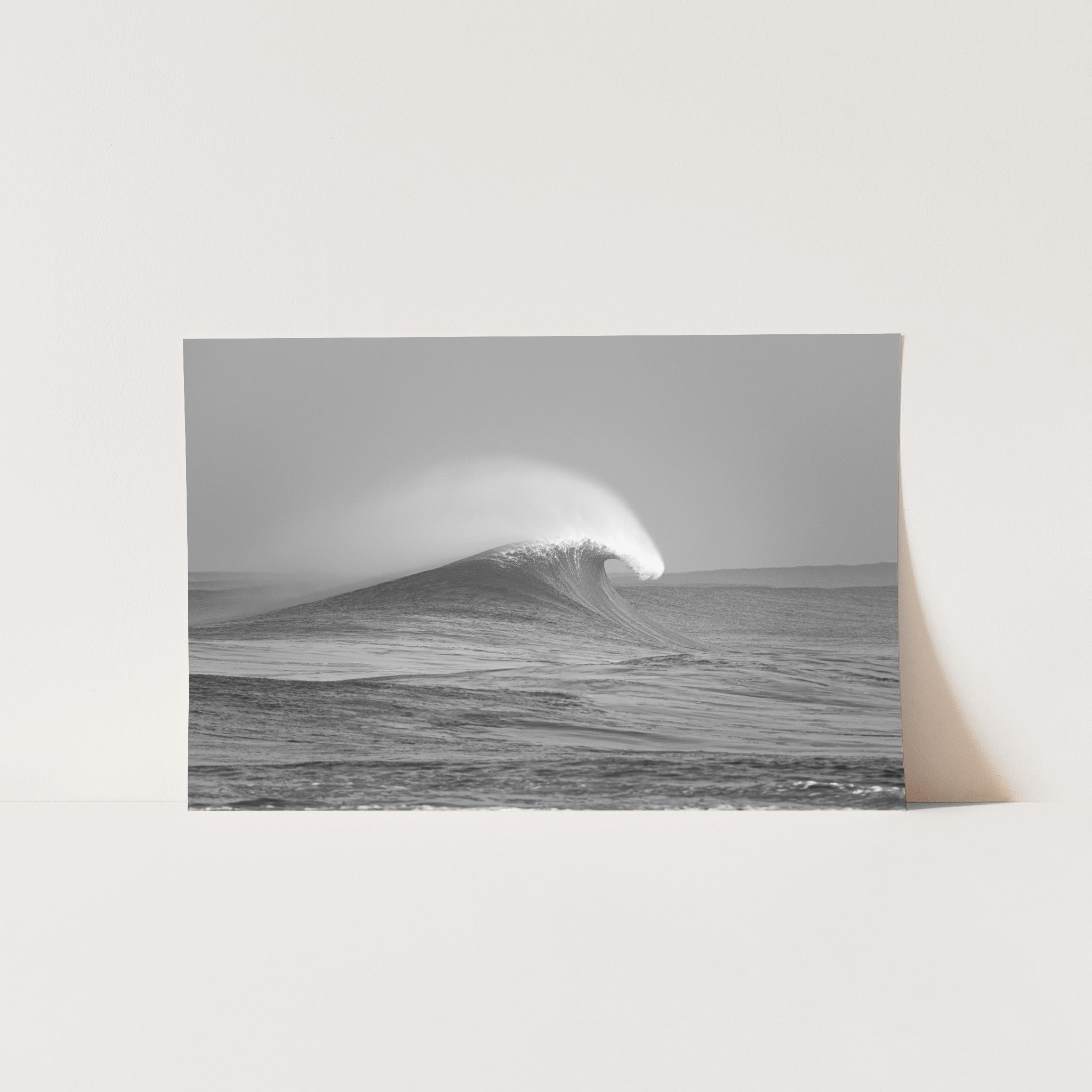 a black and white photo of a wave in the ocean