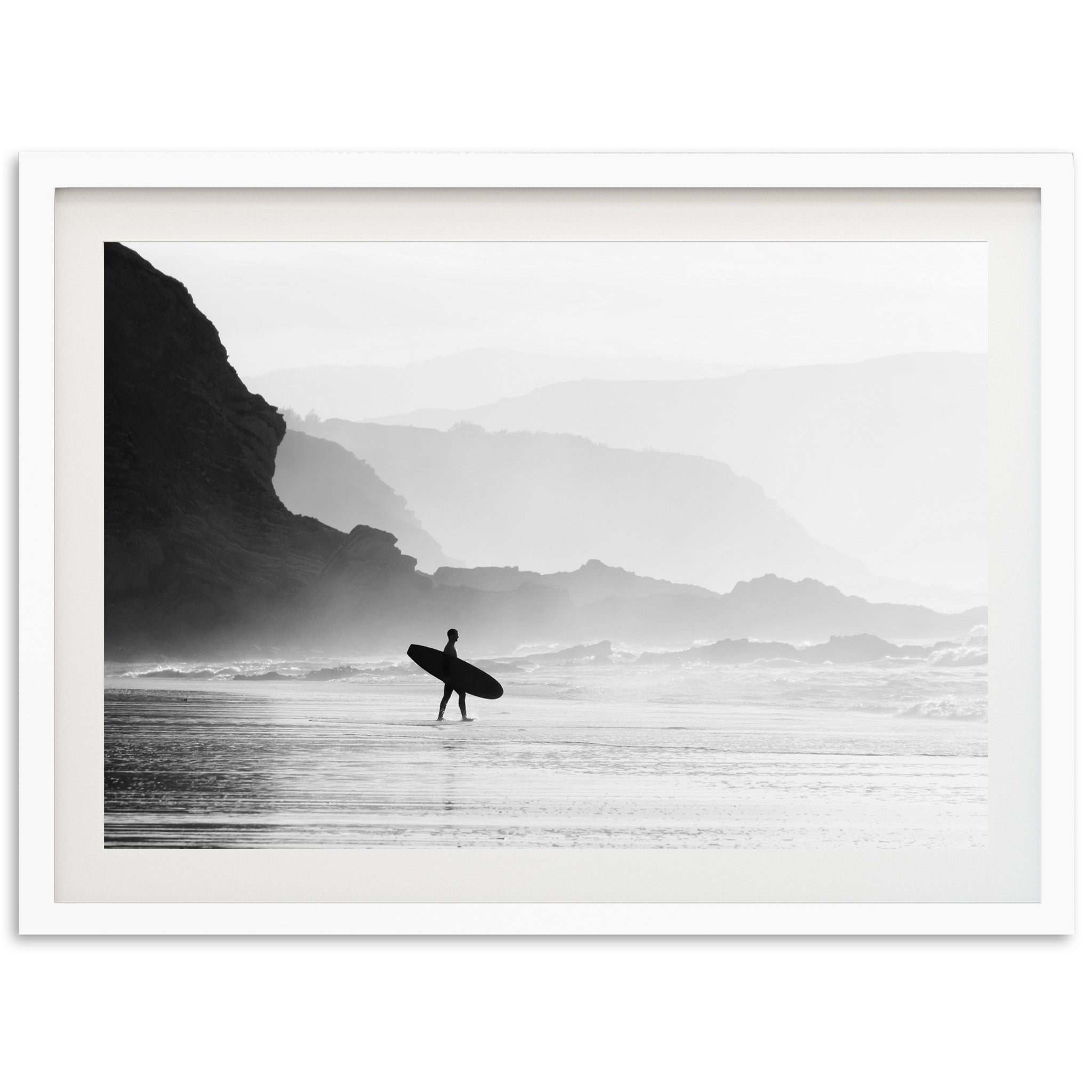 a black and white photo of a person holding a surfboard