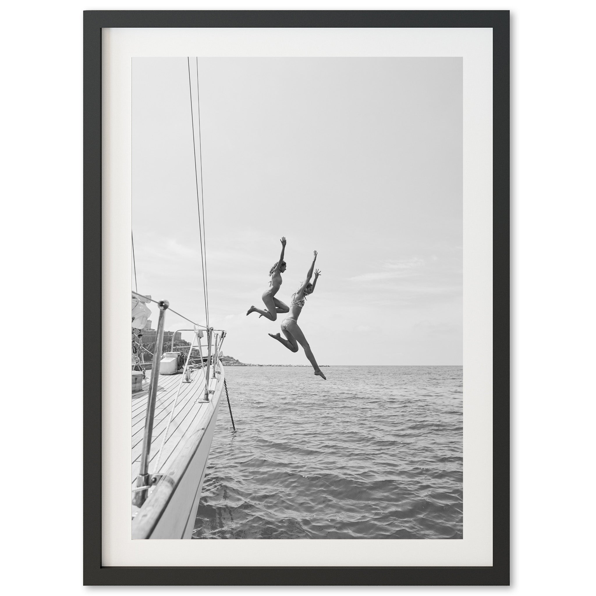 a black and white photo of a person jumping off a boat