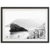 a black and white photo of people on a beach