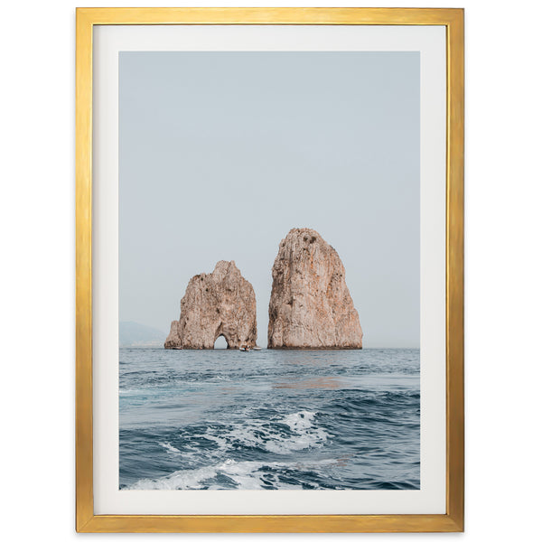 a picture of two rocks in the ocean