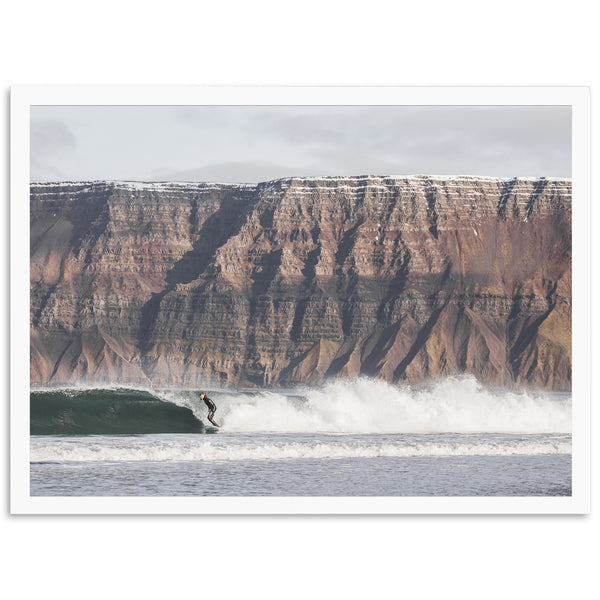 a man riding a wave on top of a surfboard