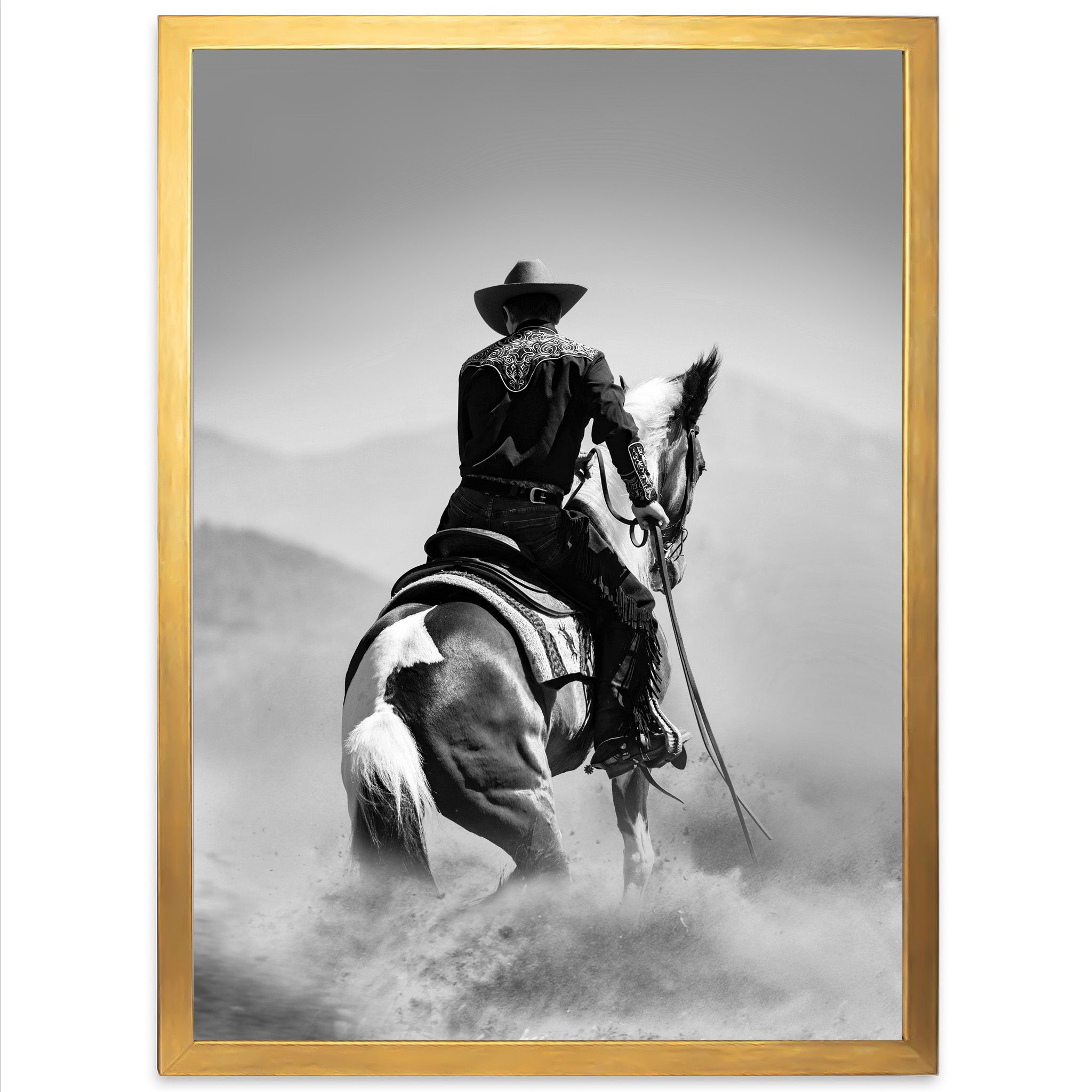 a black and white photo of a cowboy on a horse