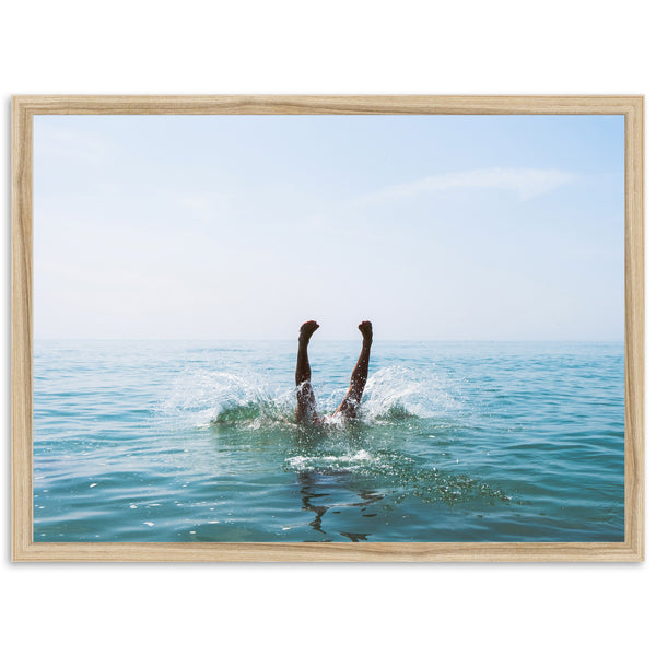 a person swimming in the ocean with their feet in the water