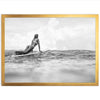 a black and white photo of a woman on a surfboard