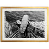 a black and white photo of a person holding a surfboard