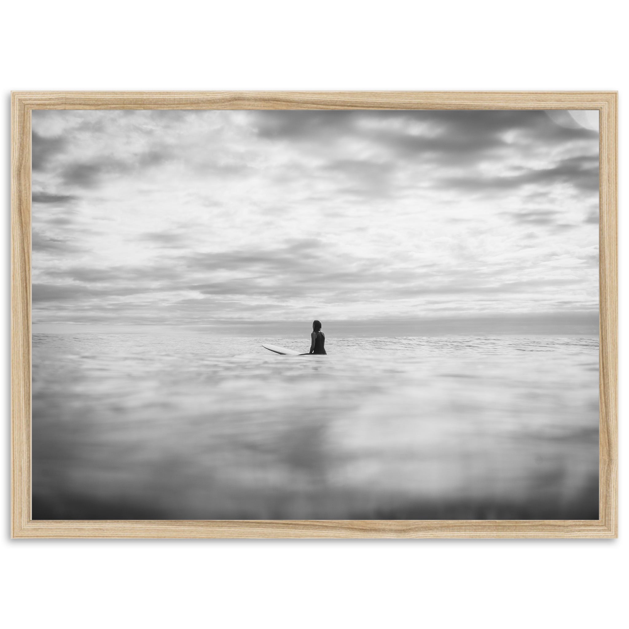 a black and white photo of a person on a surfboard