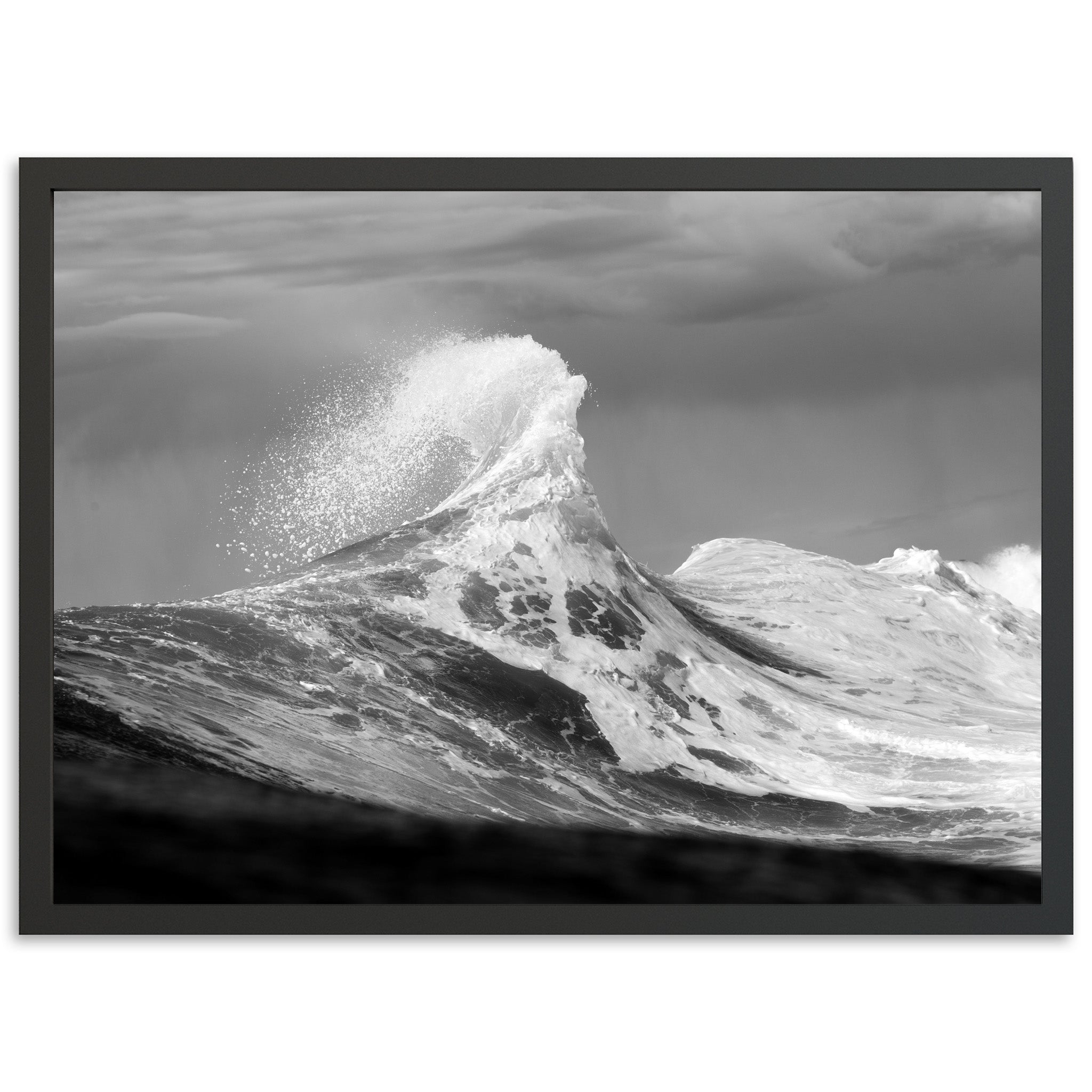 a black and white photo of a wave in the ocean