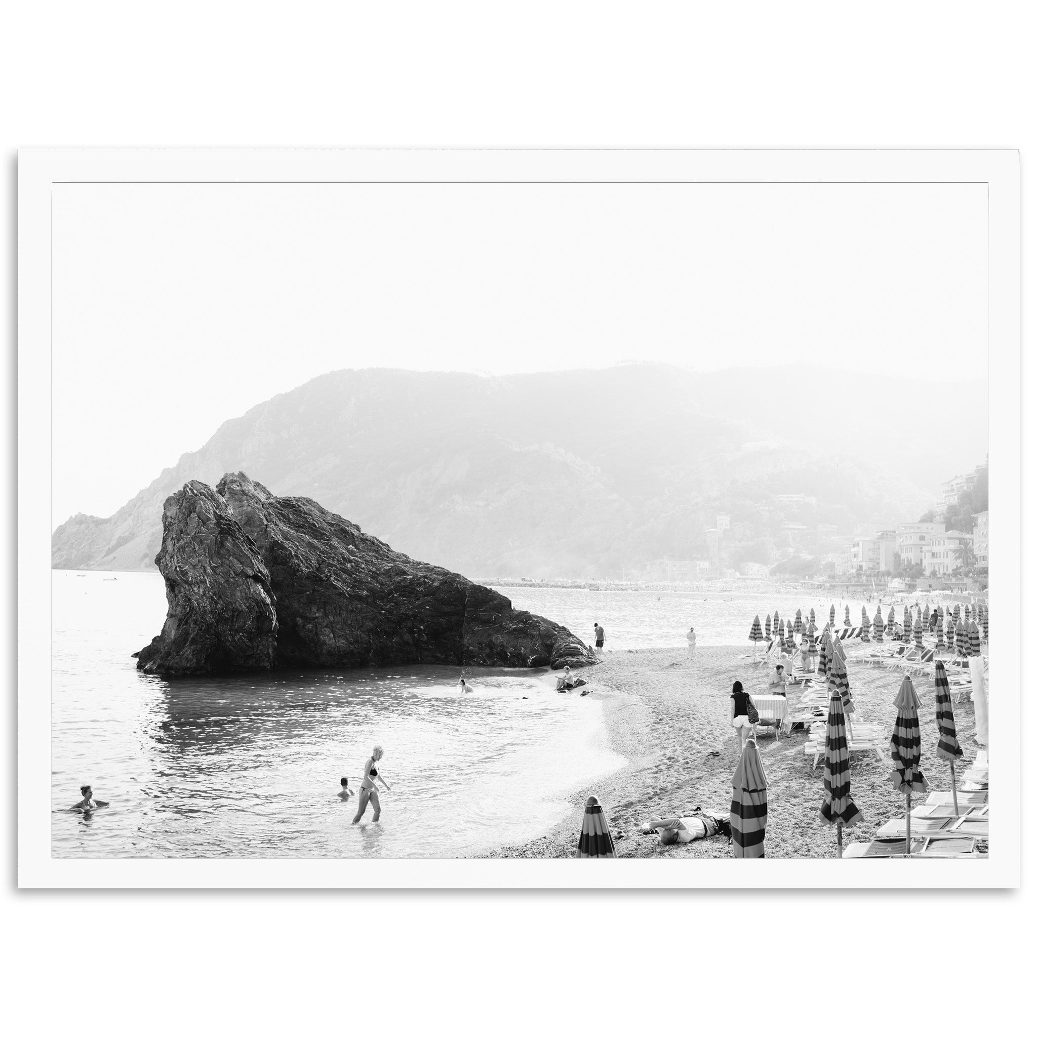 a black and white photo of people on a beach