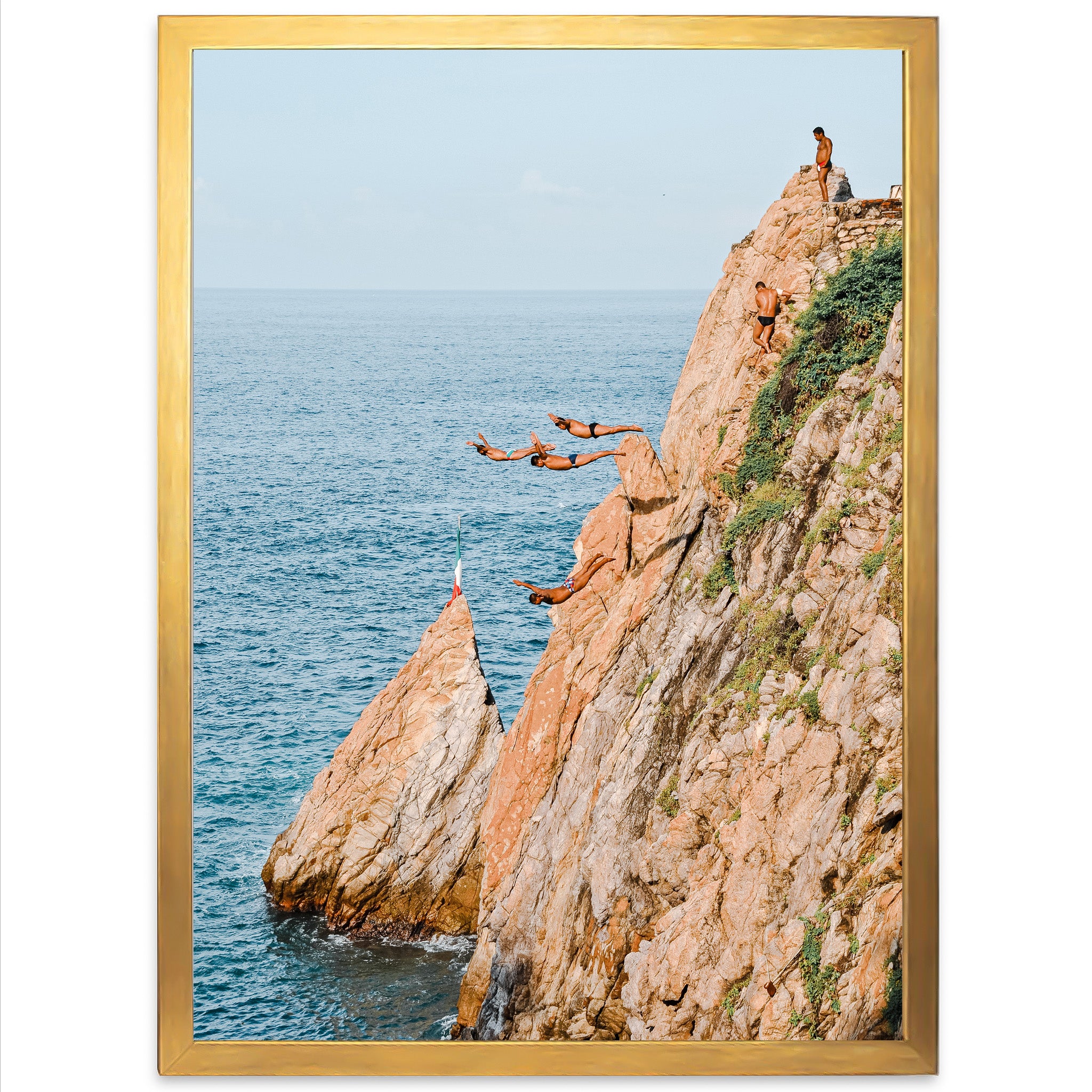 a group of people jumping off of a cliff into the ocean