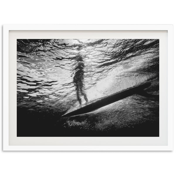 a black and white photo of a person on a surfboard