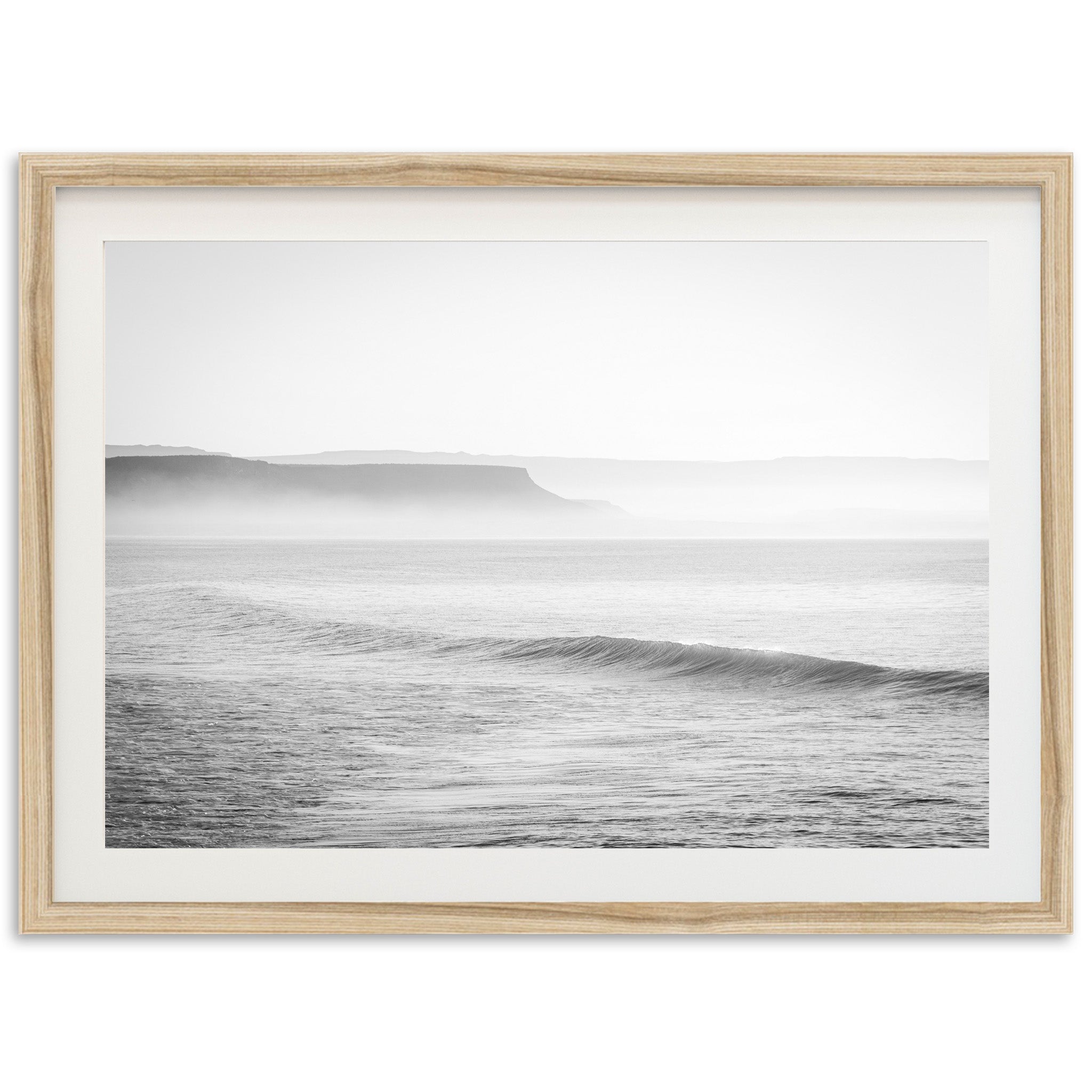 a black and white photo of a wave in the ocean