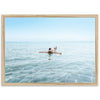 a person sitting on a surfboard in the water