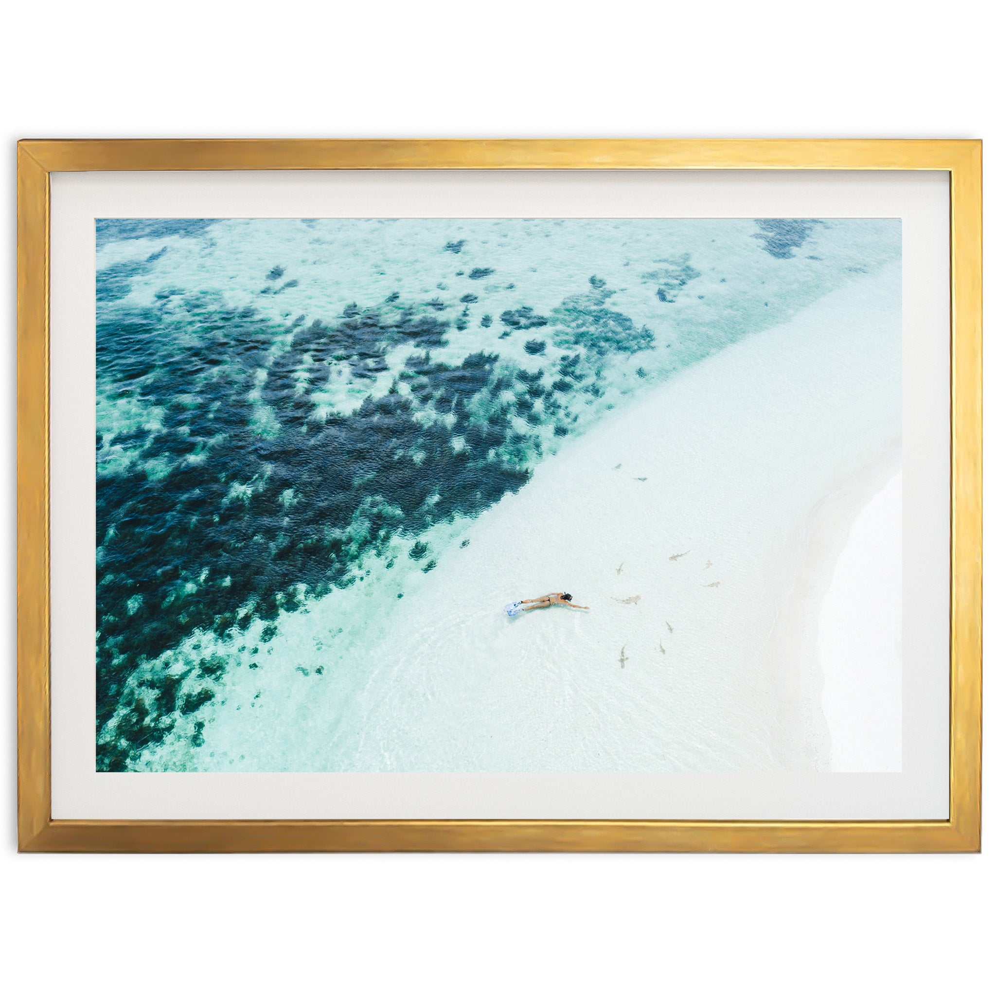 an aerial view of a beach with a boat in the water