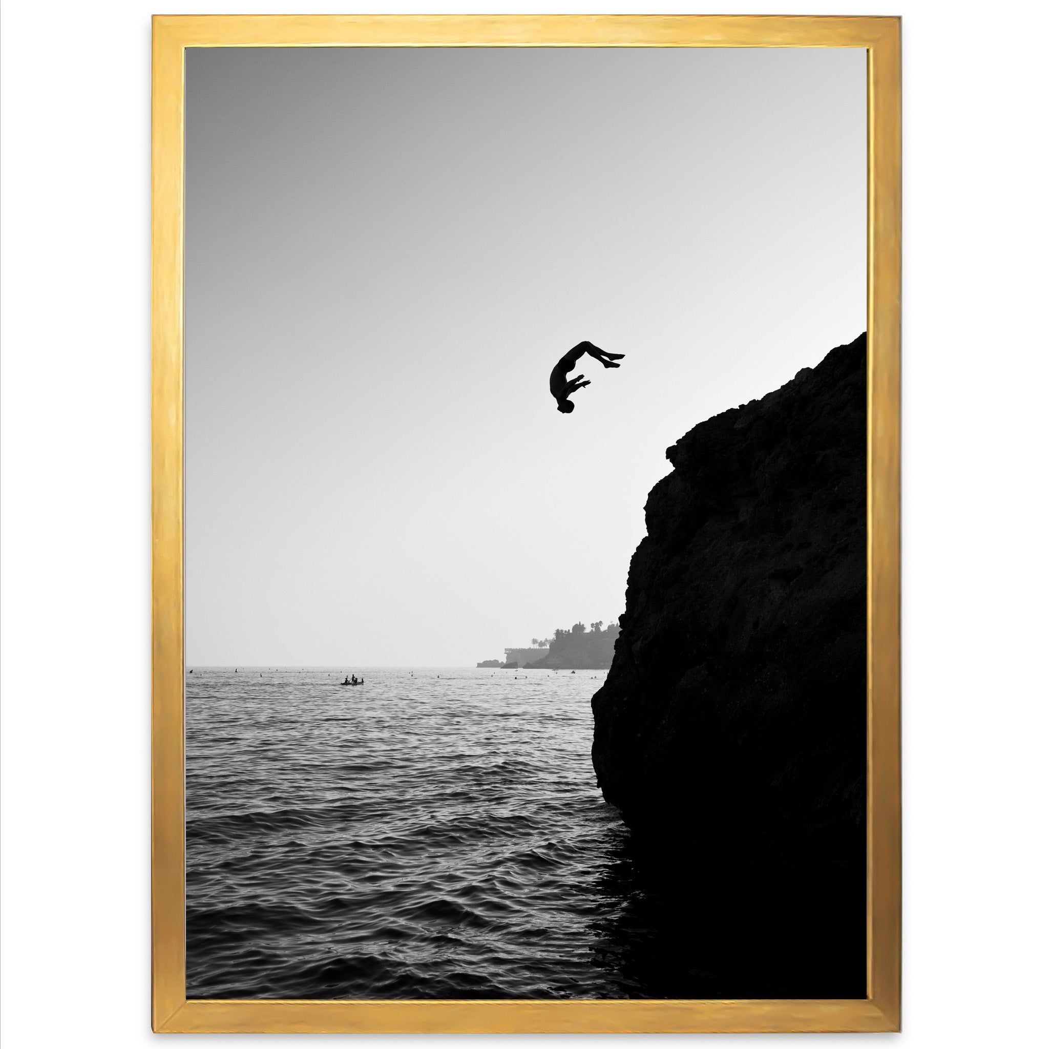 a black and white photo of a bird flying over the ocean