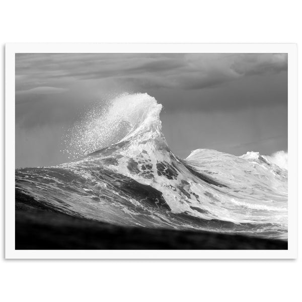 a black and white photo of a wave in the ocean