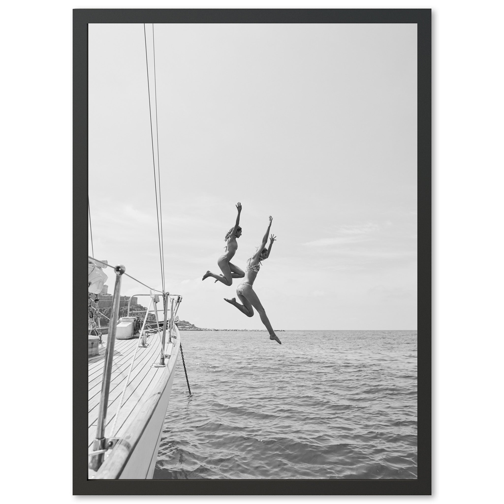 two people jumping off a boat into the water