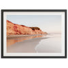 a picture of a beach with a cliff in the background