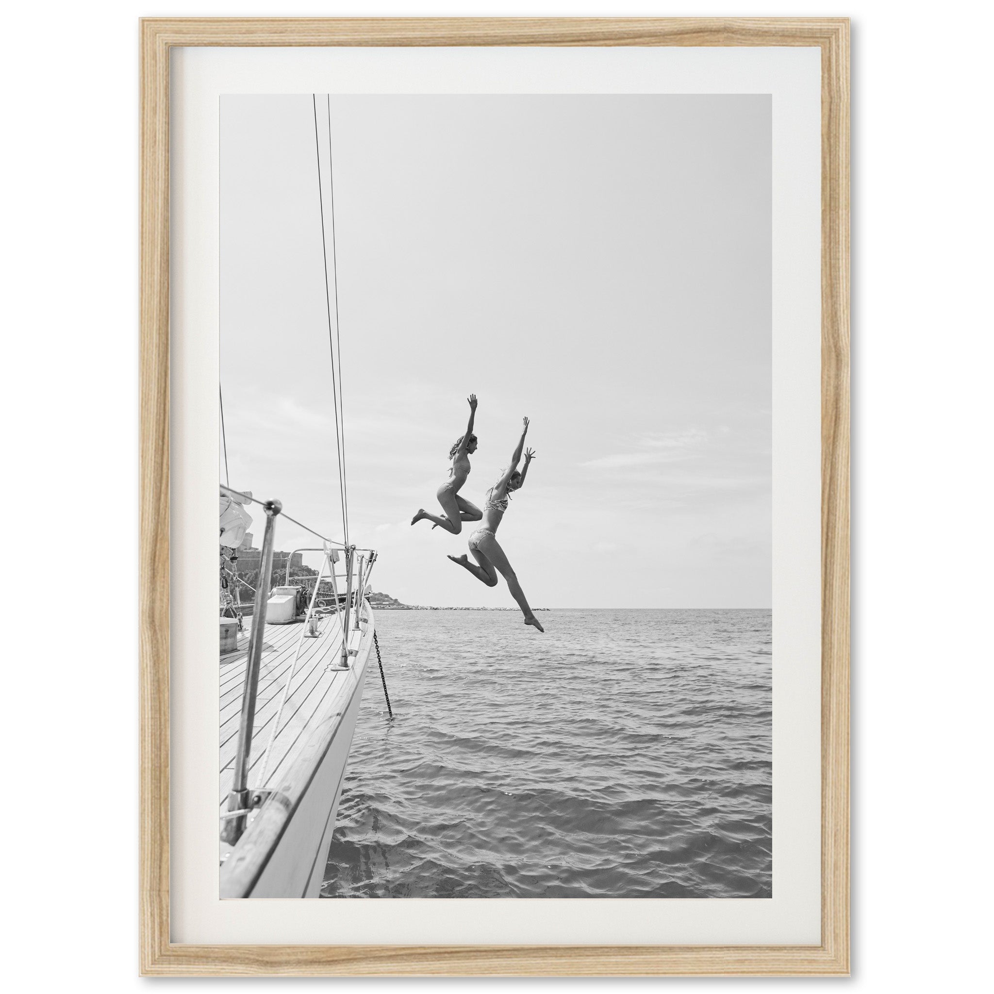 a black and white photo of a person jumping off a boat