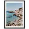 a framed photograph of people swimming in the ocean