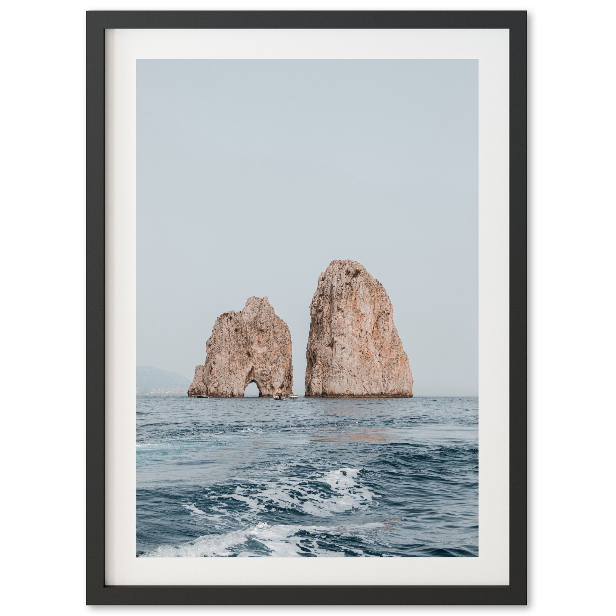 a picture of two rocks in the ocean