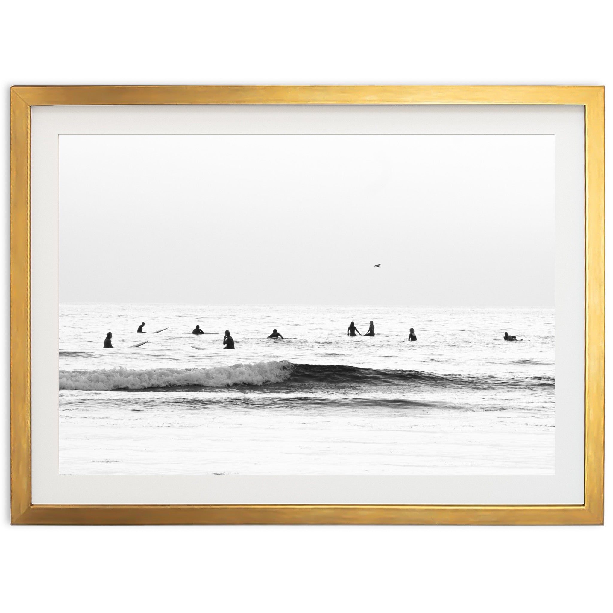 a black and white photo of surfers in the ocean