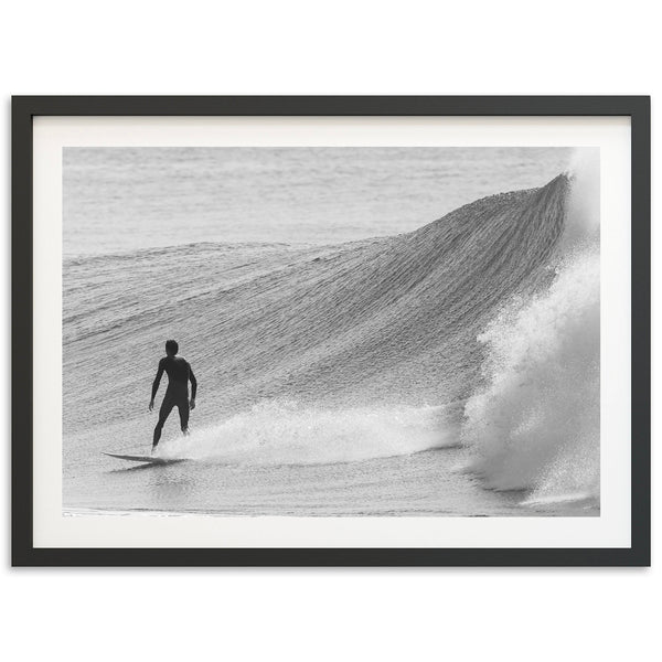 a man riding a wave on top of a surfboard