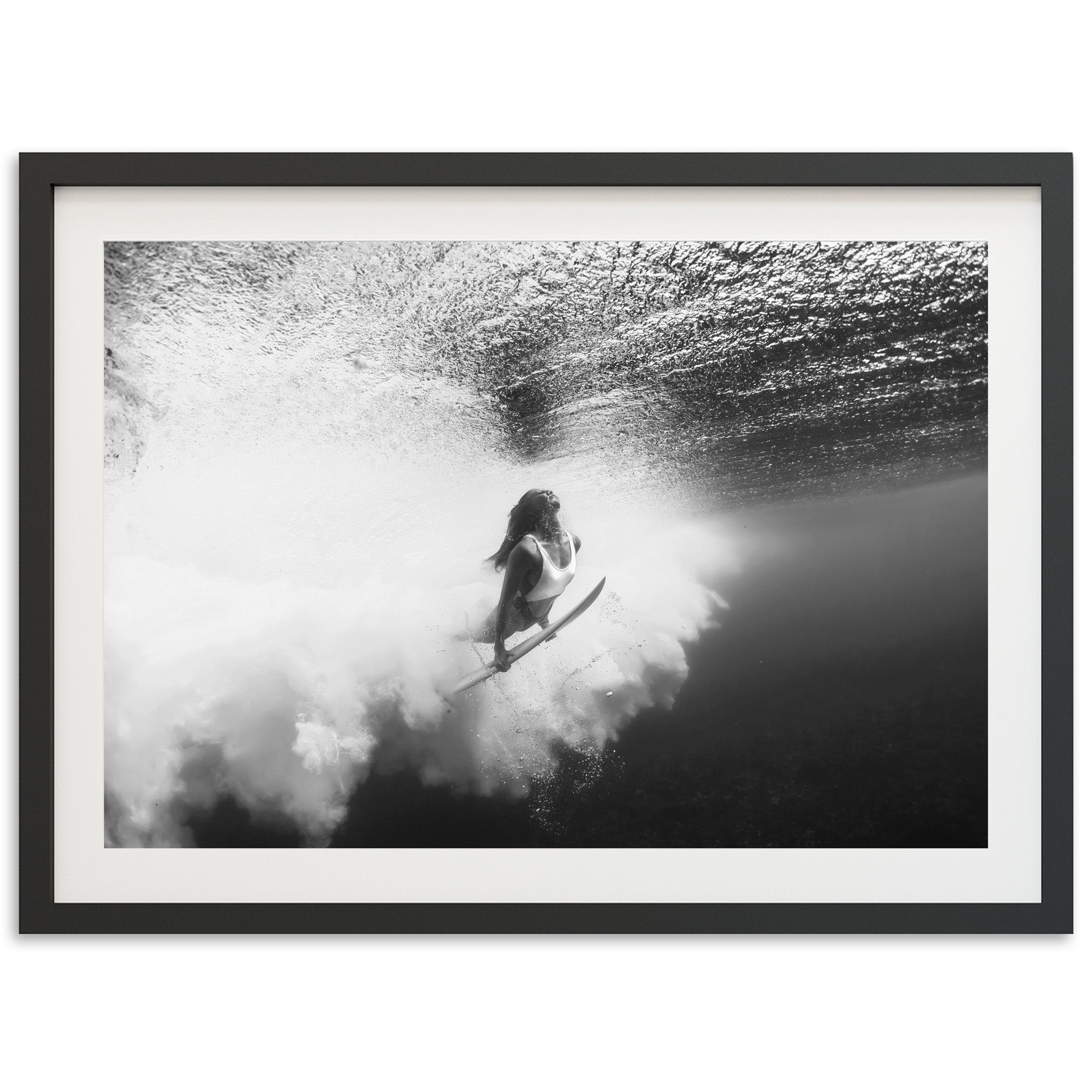 a black and white photo of a person on a surfboard